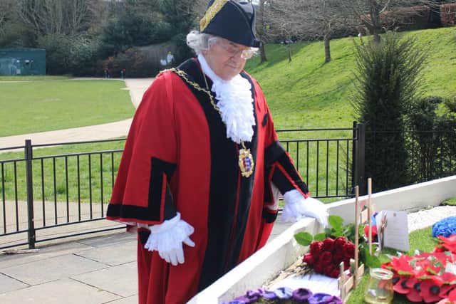 The mayor laying a bunch of red roses at the town’s war memorial earlier this afternoon.
