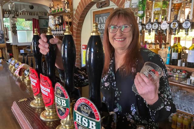 Landlady Jane Morgan raises a glass to welcome customers back to the Murrell Arms in Barnham