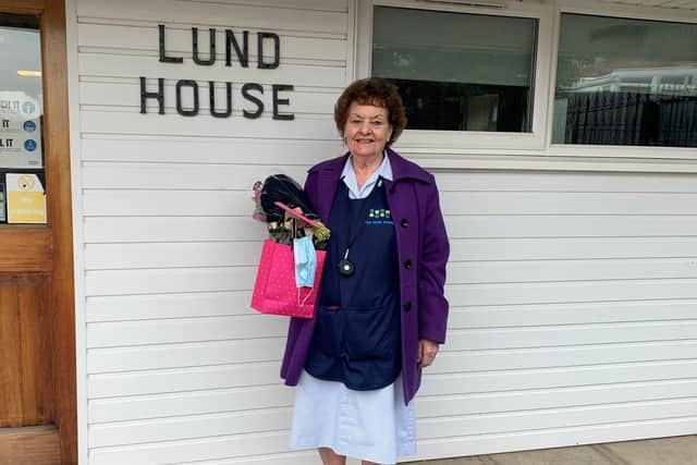 Diana Reeves with her flowers outside Lund House