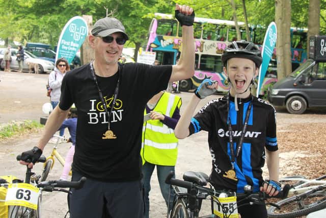 A happy father and son after completing the BHT bike ride in 2019