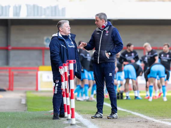 Opposing managers John Yems and Michael Duff exchange words before the game. Photo: Jamie Evans / UK Sports Images