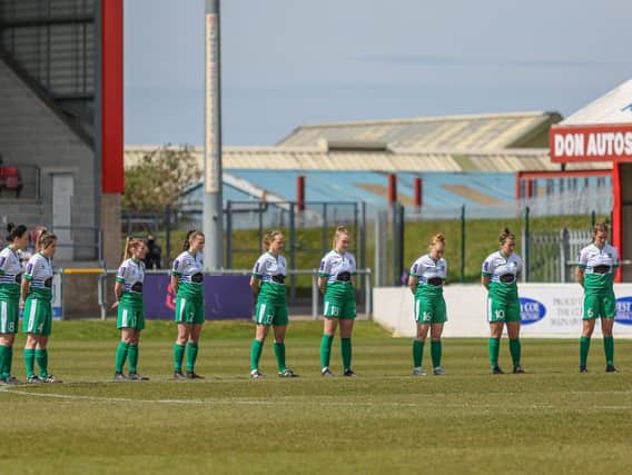 Chi and Selsey take part in the pre-match minute's silence / Picture: Sheena Booker