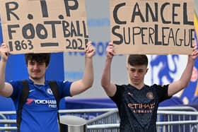 Supporters hold up placards critical of the idea of a European Super League, outside Stamford Bridge, ahead of Chelsea's game against Brighton. Picture by Justin Tallis/AFP via Getty Images