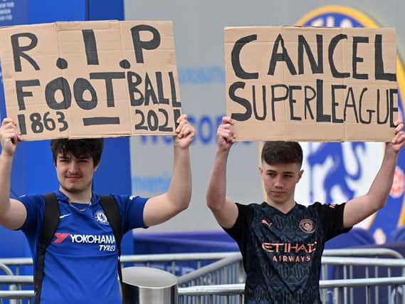 Supporters hold up placards critical of the idea of a European Super League, outside Stamford Bridge, ahead of Chelsea's game against Brighton. Picture by Justin Tallis/AFP via Getty Images