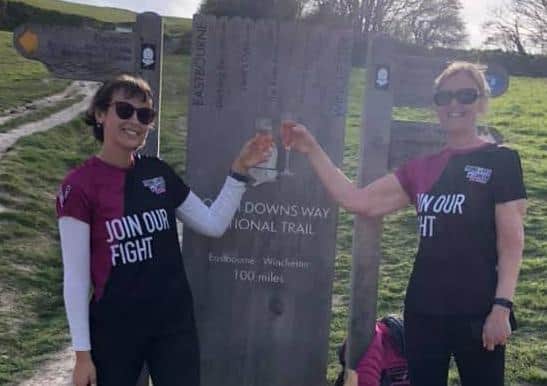 Abi and Helen Mackinnon celebrate completing their 100-mile hike along the South Downs Way to raise money for CLIC Sargent