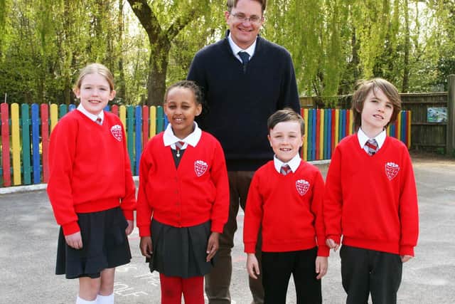 Head teacher Andrew Simpson with pupils Florence, Chloe, Oliver and Ben, all aged eight