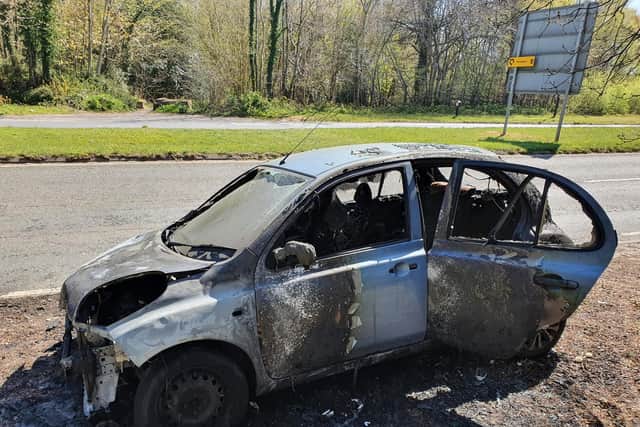 The burnt out car on the A23