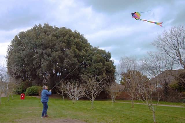 Youth leader Matt Spear flies a kite