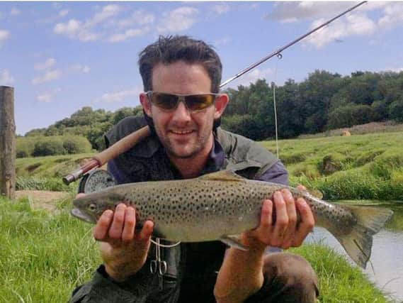 Mike Kitchener with a sea trout caught from the Rother