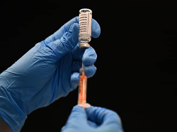 A healthcare professional draws up a dose of the Oxford/AstraZeneca Covid-19 vaccine at the vaccination centre set up inside Brighton Centre