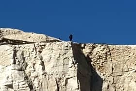 A still image of the man at the cliff edge - taken from the video by Paul Burns
