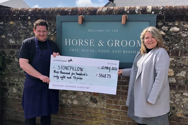 Gary McDermott, head chef and manager of the Horse & Groom presents a cheque to Stonepillow chief executive Hilary Bartle