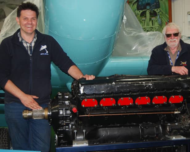 Pictured are Tony Hoskins, director of the Spitfire AA810 Project, and museum curator Charles Hutcheon with the Merlin XX engine. Photo by Mike Bennett