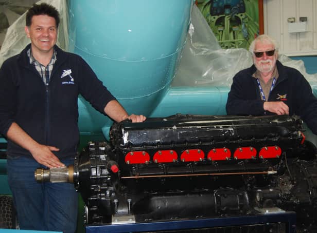 Pictured are Tony Hoskins, director of the Spitfire AA810 Project, and museum curator Charles Hutcheon with the Merlin XX engine. Photo by Mike Bennett