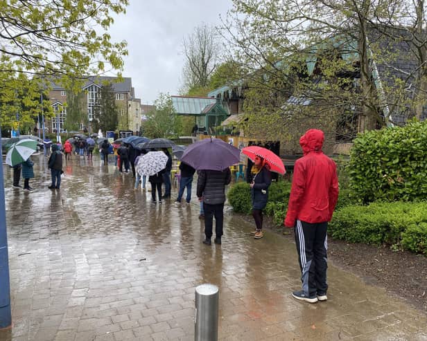 People queued for hours in torrential rain to get their Pfizer vaccination. Photo: David Soulsby