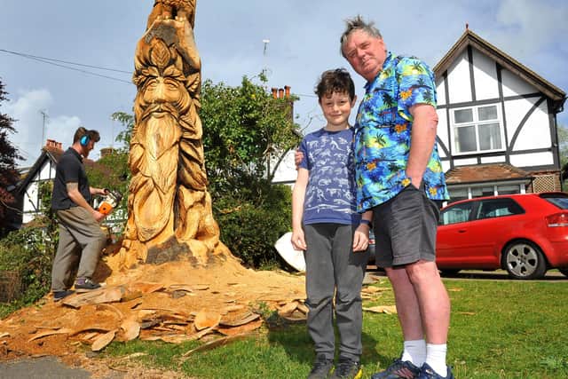 Alasdair Craig of Sussex Chainsaw, with the house owner John Troake and his grandson Dylan next to the nearly completed sculpture. Picture: Steve Robards SR2105185