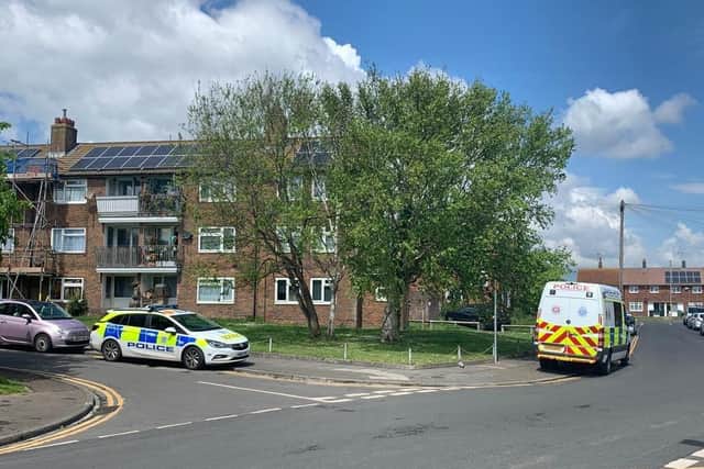 Police vehicles attend the incident at a block of flats in Langney. SUS-210519-121931001