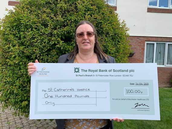 Wykeham House care home in Horley recently presented its local St Catherine’s Hospice with a cheque for £100. Picture courtesy of Barchester Healthcare Ltd