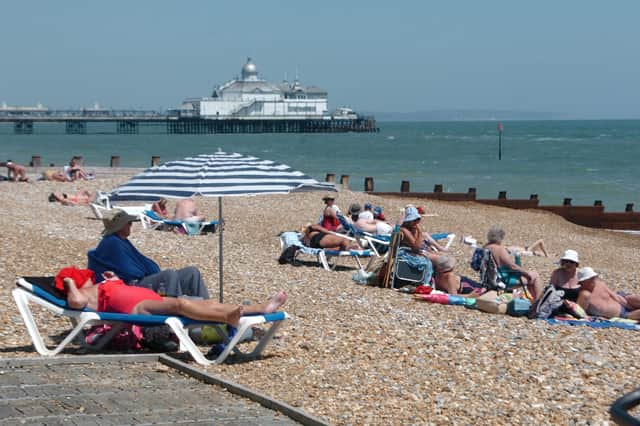 Residents and tourists relaxing in the sun on Eastbourne beach. E28194P ENGSUS00120130907102813