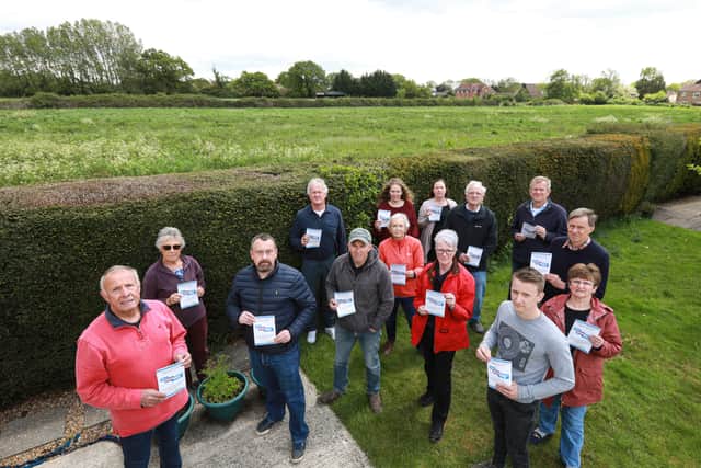 Nutbourne residents, including Dave King, front left, are concerned about proposals to build 1250 homes in Southbourne Parish. The land behind them lies within the plans Picture: Chris Moorhouse