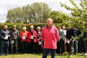 Nutbourne residents, including Dave King, front, are concerned about proposals to build 1250 homes in Southbourne Parish. The land behind the hedge lies within the plans Picture: Chris Moorhouse