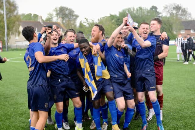 Lancing's players celebrate their shield win - which came four days after their promotion to the Isthmian League had been confirmed / Picture: Stephen Goodger