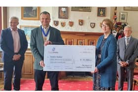 Cllr Wallis (front left) presenting cheque to Ann Gillard with Keith Ridley (back left) and Charles Grimaldi (back right), from People Matter. SUS-210526-111217001