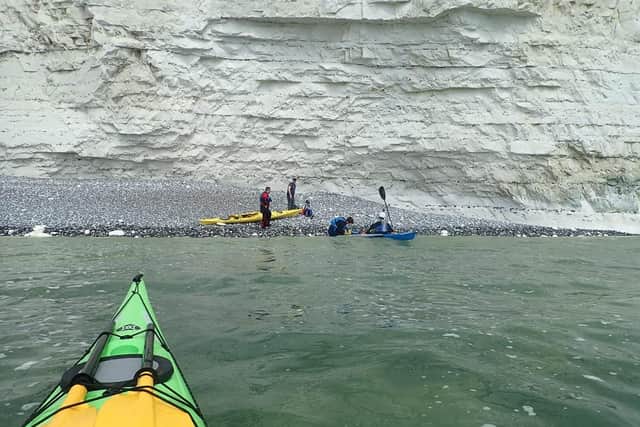 A father and son being rescued by local kayakers from Cuckmere Valley Canoe Club. SUS-210527-113855001