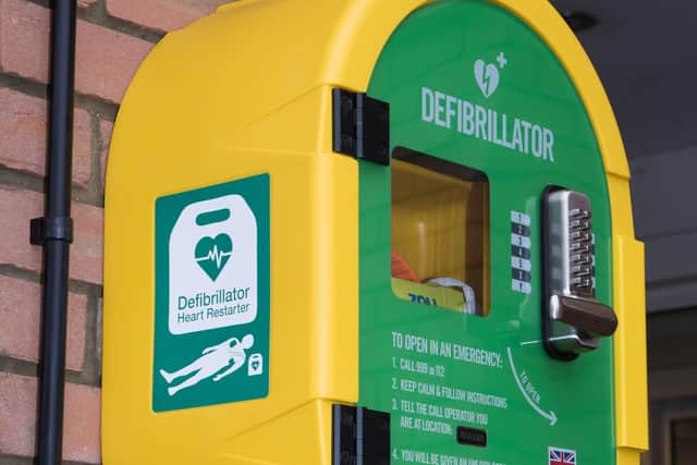 A defibrillator in its protective cabinet.