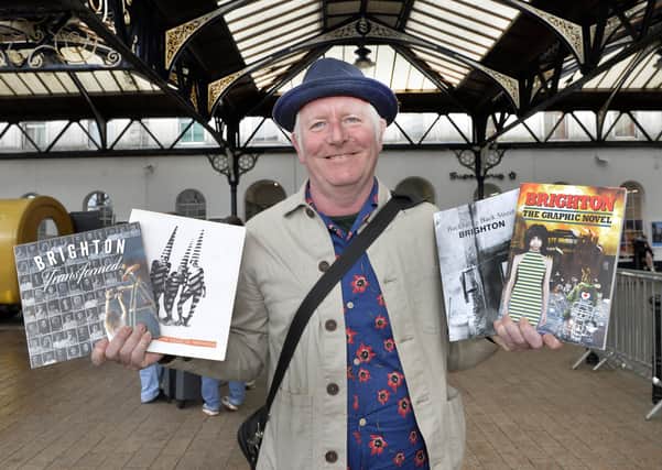 John Riches, development director of QueenSpark Books, with some of the books it has previously published. Photo by Jon Rigby