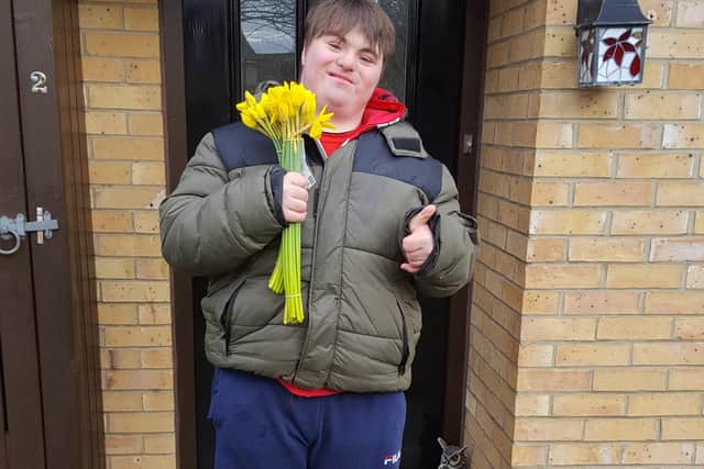 Jack Lawlor, who has Downs Syndrome, has played a part by delivering the leftover flowers and daffodils to residents on the Swanfield Park estate as he took his daily exercise