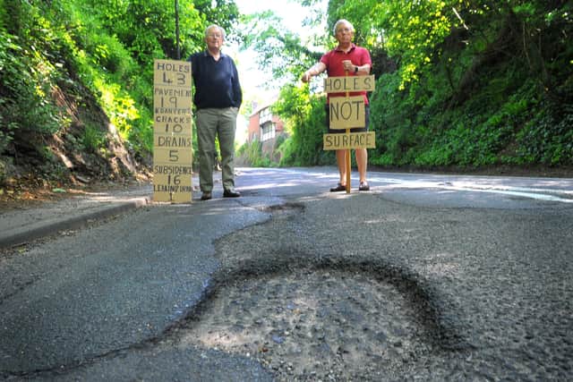 John Budgen and John Rogers are concerned about the state of the potholed road on the A29 Church Hill, at Pulborough. Photo: Steve Robards SR2105311 SUS-210531-213621001