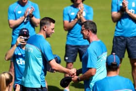 Ollie Robinson is handed his cap by Jon Lewis / Picture: Getty