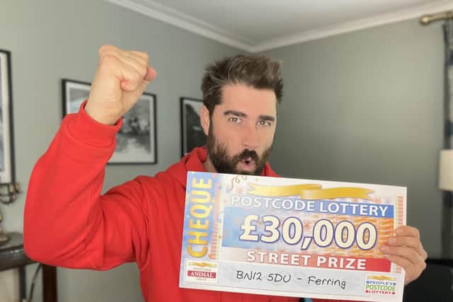 People's Postcode Lottery ambassador Matt Johnson with the Ferring winner's £30,000 cheque