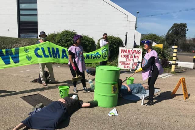 Four protesters locked themselves to oil barrels and are lying across the entrance to the facility in Hamble Lane preventing tanker lorries from accessing the site. Photo: Extinction Rebellion