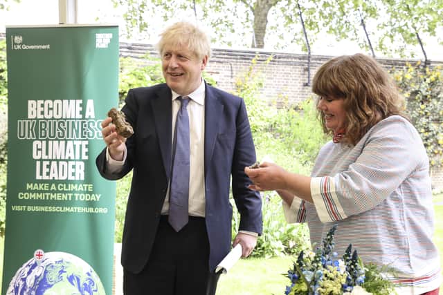Prime Minister Boris Johnson with Pulborough florist Claire Denman N10-2387-0009