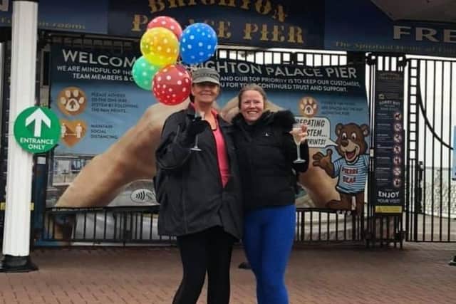 Sharon Smith with Laura Tacey after completing the walk to Brighton pier. SUS-210306-133356001