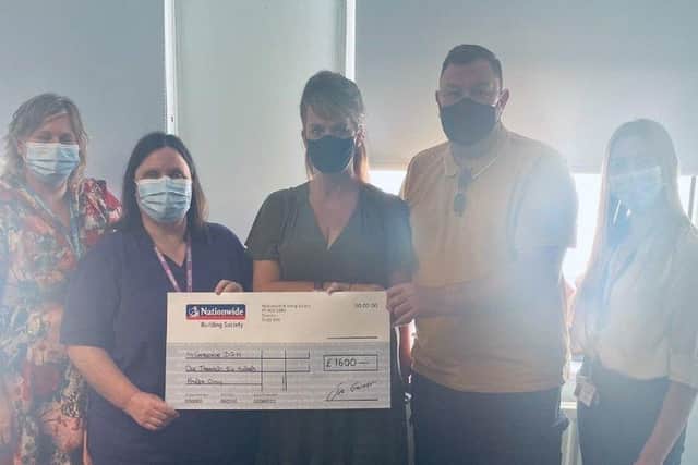 Mark Williams and Sharon Smith handing over the donation at Eastbourne DGH. SUS-210306-133311001