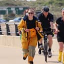 From left, Hannah Presgrave, Ian Foden and Bea Homer running and cycling in Littlehampton as part of their epic fundraising challenge. Picture: RNLI/Beth Brooks