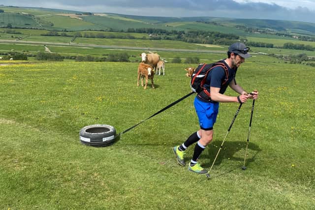 Josh Braid, from Hurstpierpoint, pulling his tyre across the South Downs Way.