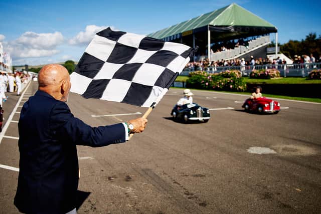 A tribute to Sir Stirling Moss (pictured waving the chequered flag in 2016) will take place at this year's Revival - Photo by Dominic James