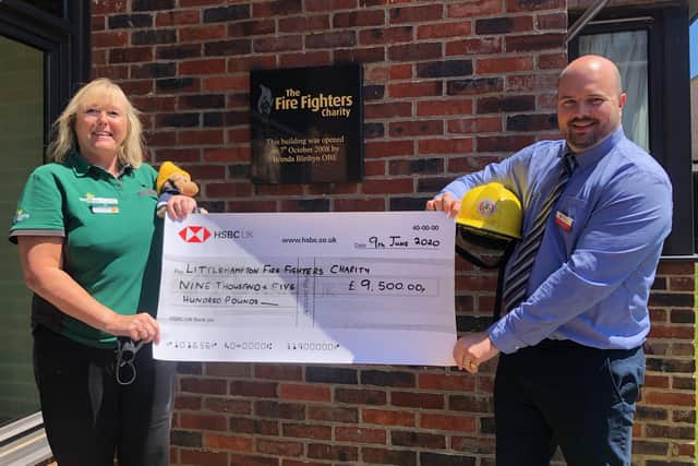 Alison Whitburn, community champion at Morrisons Littlehampton, presents James Sandercock, Marine Court estates and facilities manager, with a £9,500 cheque for The Fire Fighters Charity