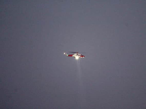 A helicopter searches the area
