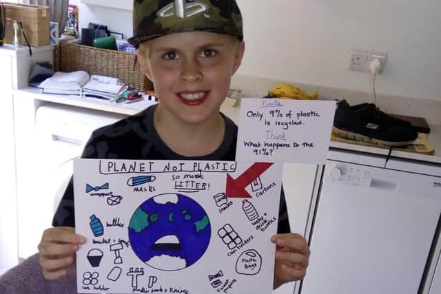 Jamie Hewitt, aged 9, from Horsham, put up a poster in Shoreham to encourage people not to litter SUS-210614-150317001