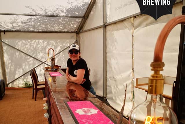 Holly Saunders behind the bar in the Brolly Beer Tent