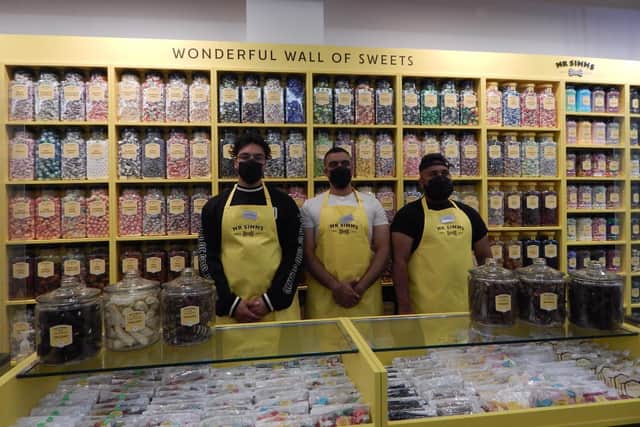 The staff at Mr Simms in front of the Wonderful Wall of Sweets