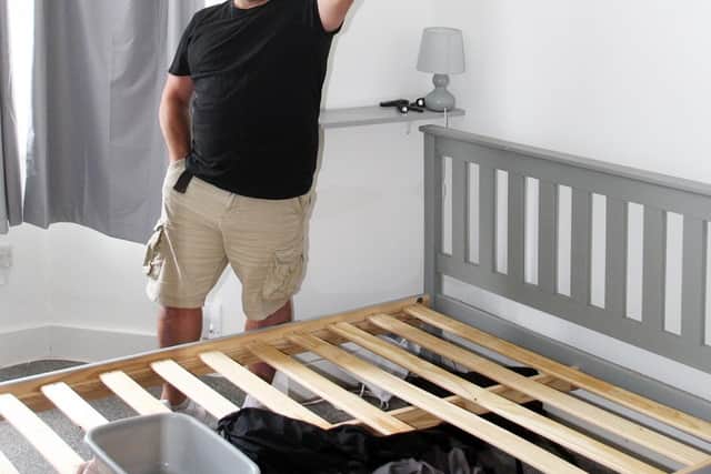 Shaun Llewellyn in his Worthing flat where water is coming through the ceiling caused due to a bird's nest. Photo by Derek Martin Photography
