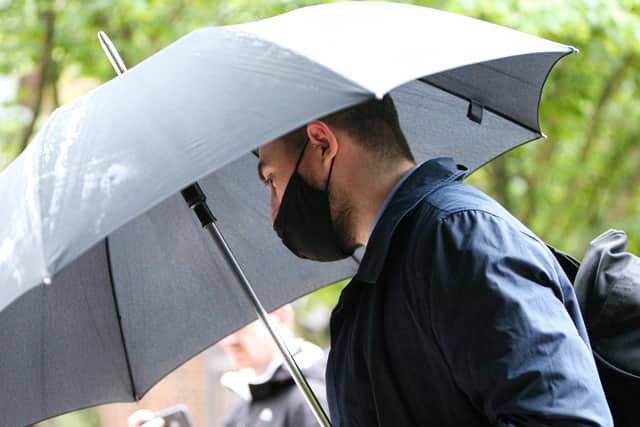 Former PCSO Joshua Fitzjohn leaves Portsmouth Crown Court wth an umbrella having being sentenced for coercive control of his wife