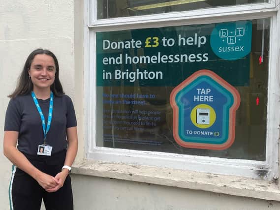 Juliet Hinton-Smith, community fundraising officer for BHT Sussex, outside the charity showing the new tap to donate device