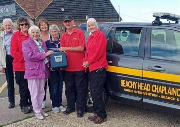Left to right: Mike Keller, Flora Richards and Lys Page presenting the
defibrillator to members of the Beachy Head Chaplaincy Team SUS-210624-094039001
